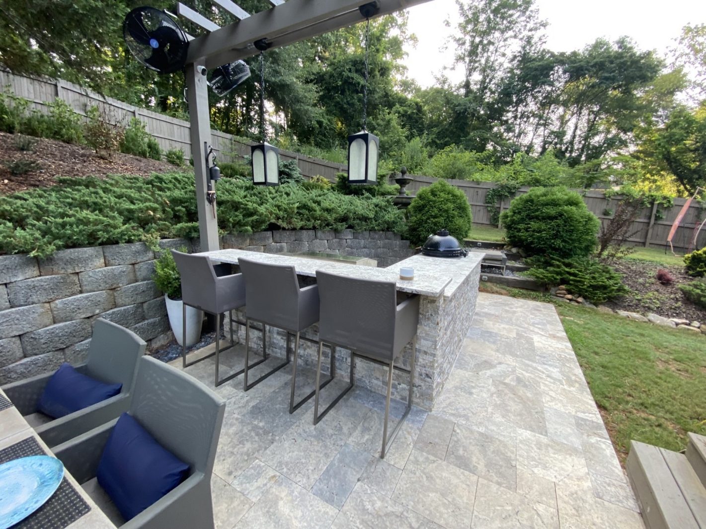 A beautiful, modern outdoor kitchen connected to a pergola.